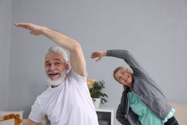 Smiling elderly couple exercising at home. Healthy leisure Smiling elderly couple exercising at home. Healthy leisure